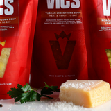 Three red Vics bags on a table with ingredients in the foreground