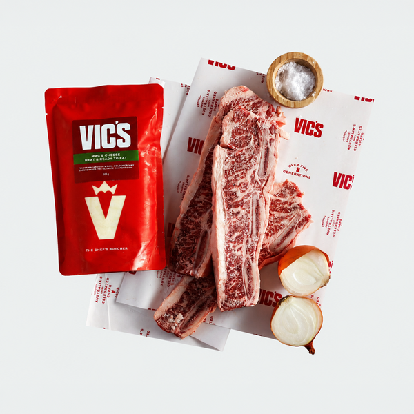 Raw beef ribs with Vics packaging and ingredients on a white background