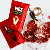 Red Vics packaging with raw steaks on a white background