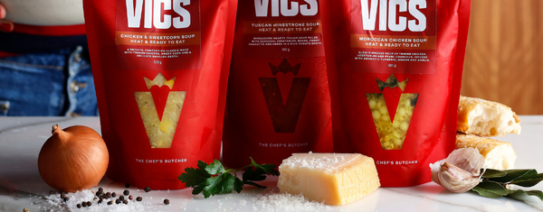 Three red Vics bags on a table with ingredients in the foreground