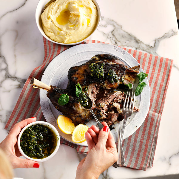 Lamb roast with chimichurri topped over plate.